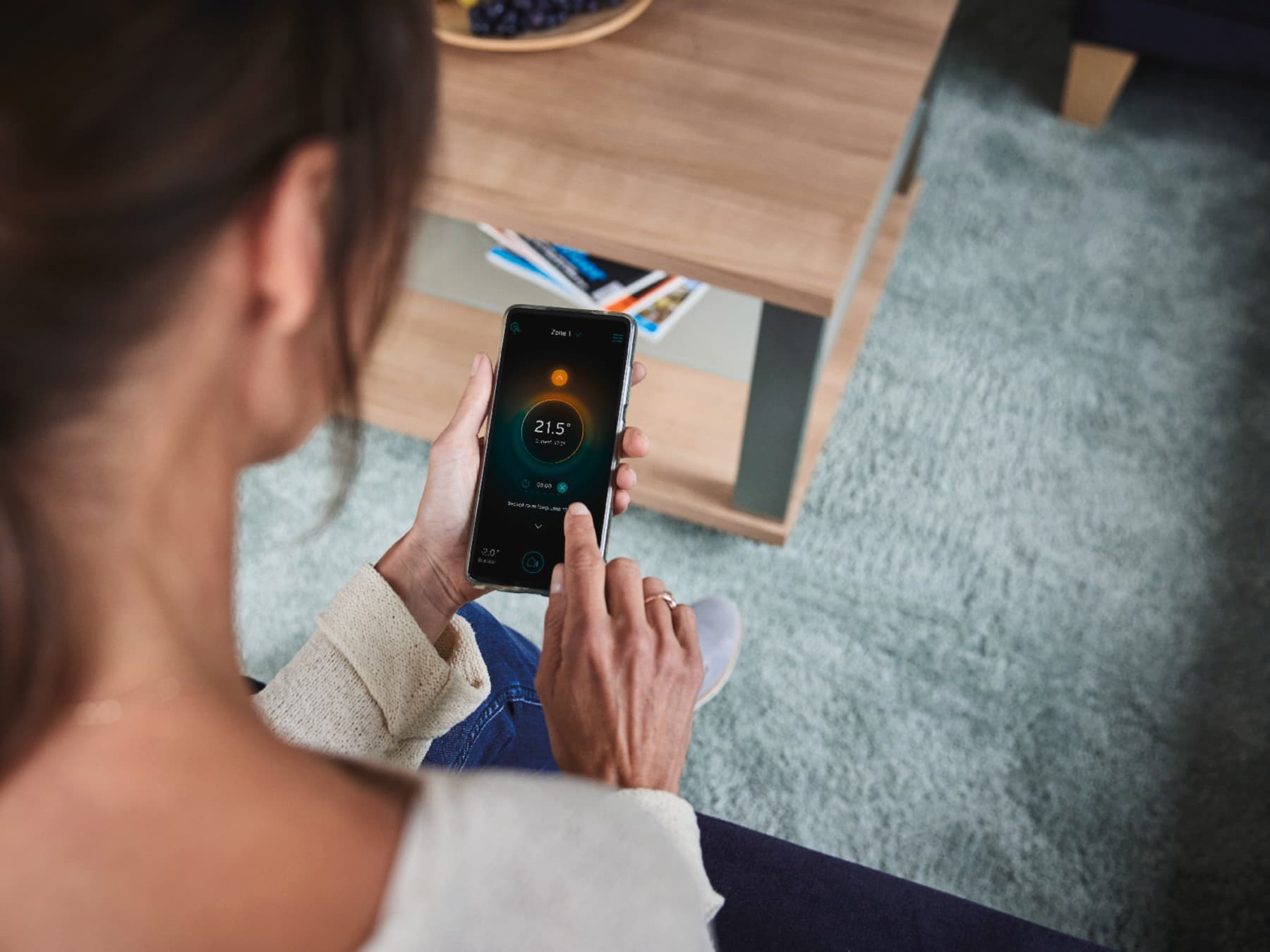 Mulher a configurar o seu sistema inteligente no telemóvel.
