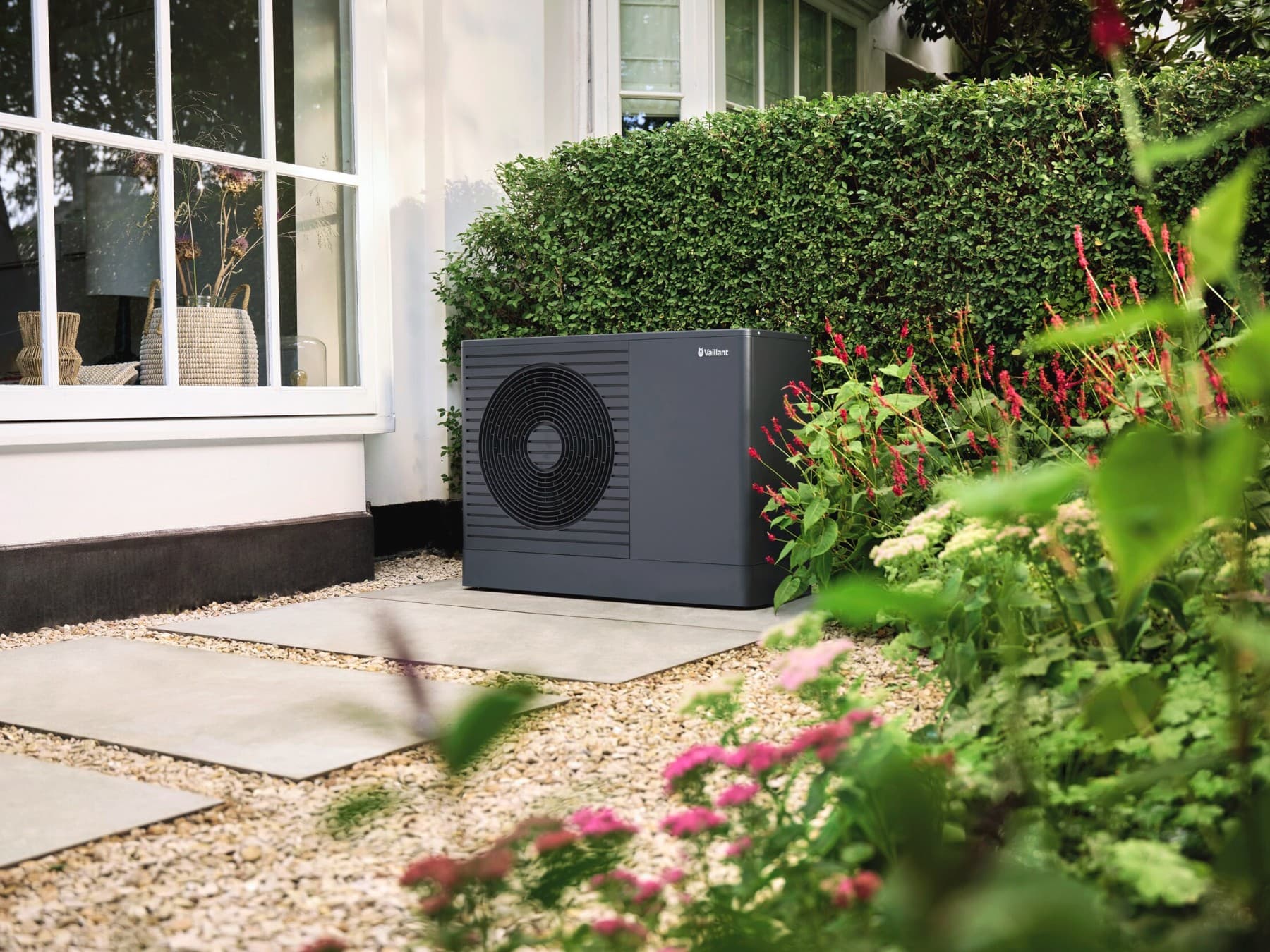 Bomba de calor ar-água aroTHERM pro no jardim da frente de uma cas