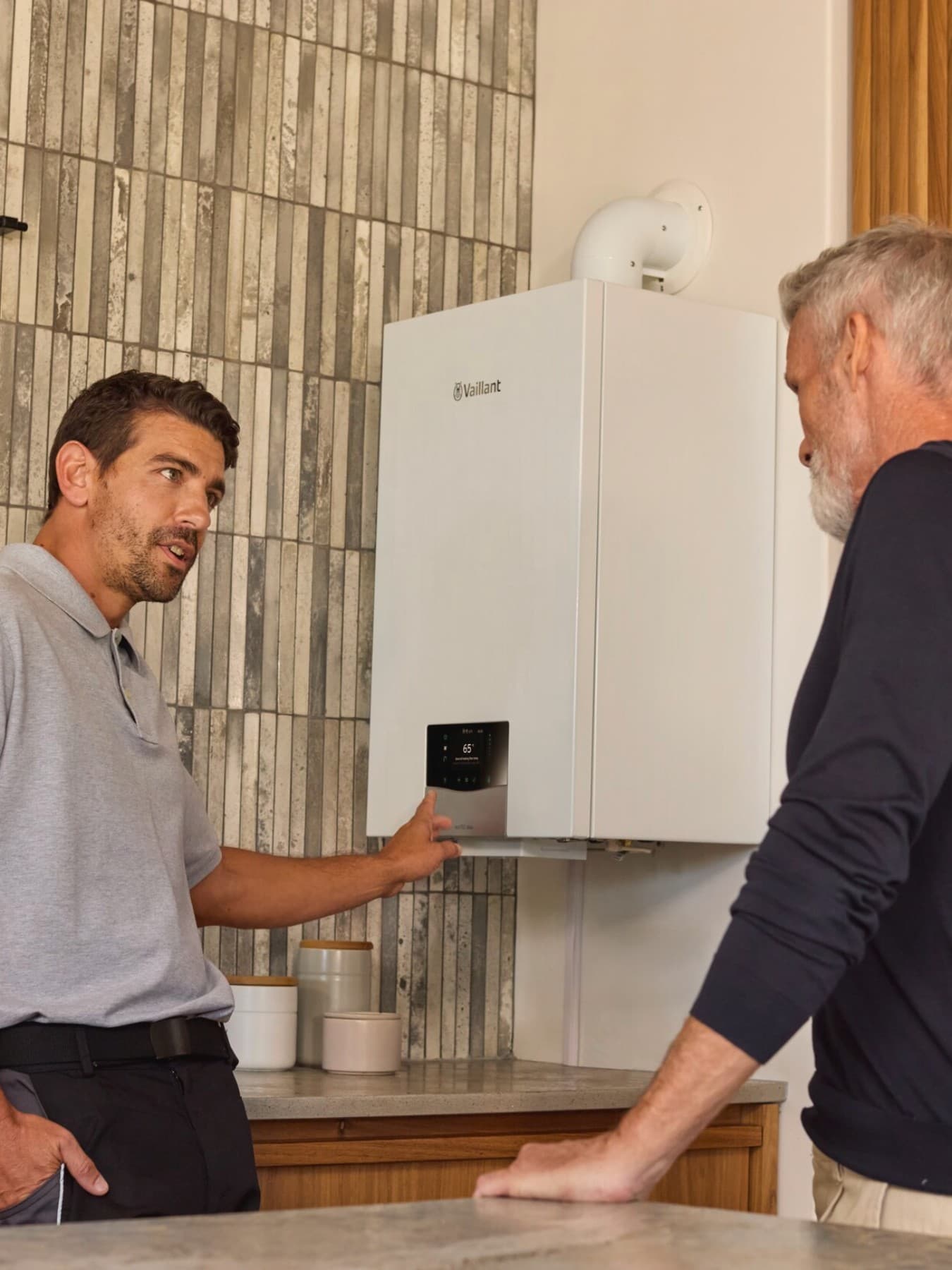 Um instalador a explicar uma caldeira a um homem